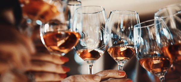 Andover Wine Merchant | Our Story featuring a clinking of glasses with Rosé wine